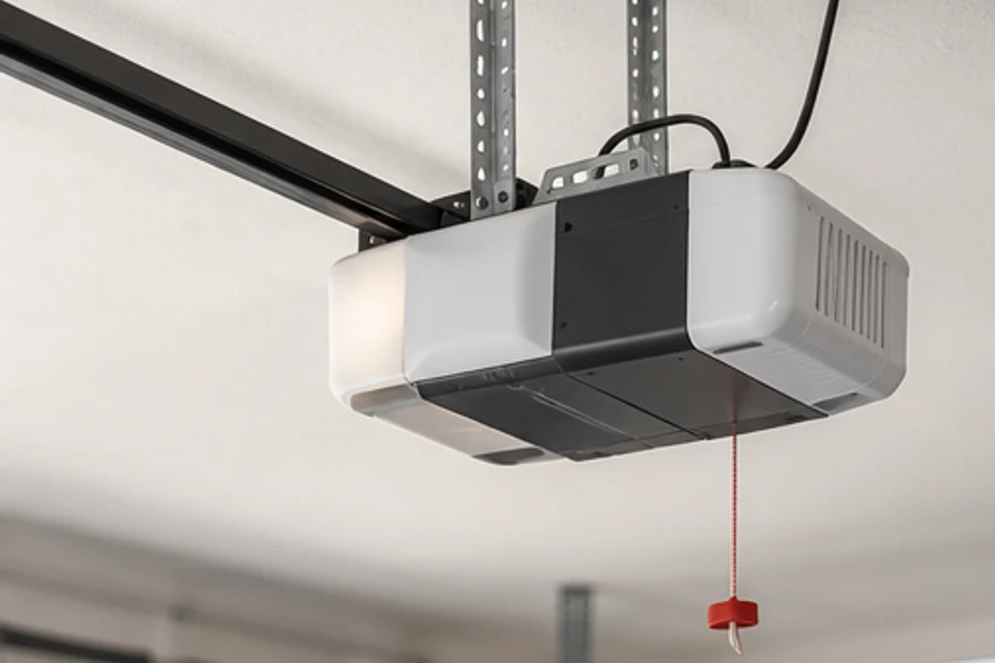 A garage door opener hangs from ceiling brackets with a red release cord.